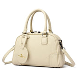 Sac à main poignées et bandoulière beige de trois quarts