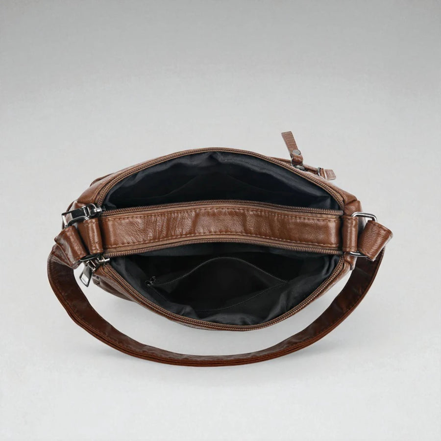 Sac bandoulière cuir souple multiples poches intérieur