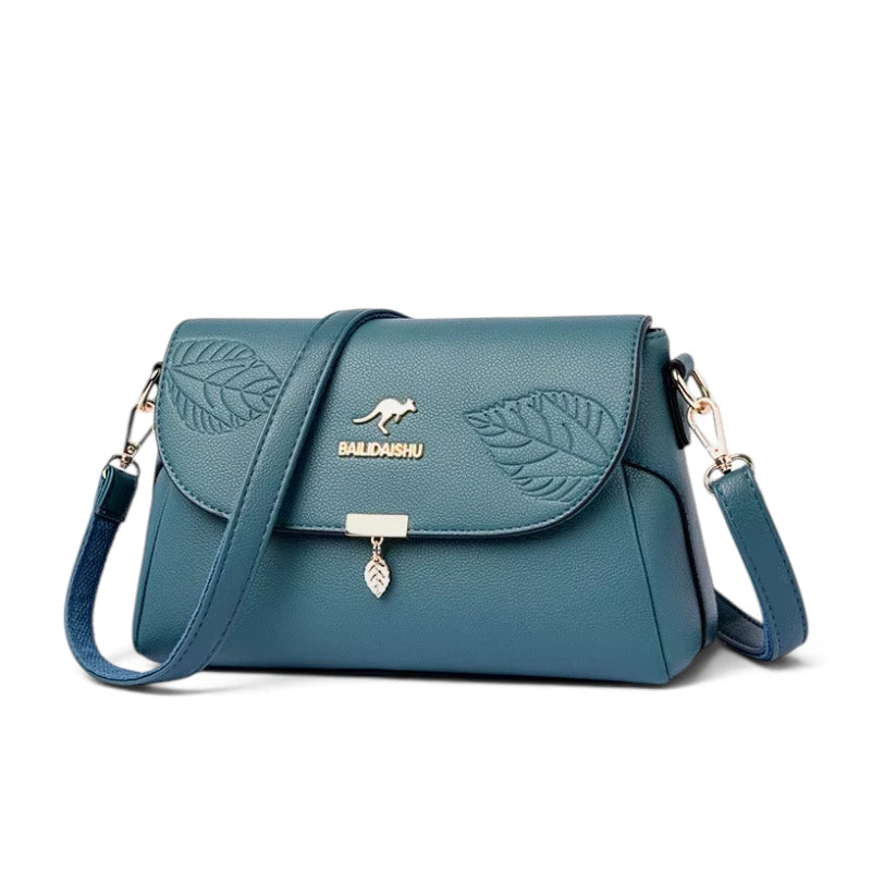 Sac bandoulière femme cuir bleu motif feuille, vue de trois quarts