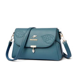 Sac bandoulière femme cuir bleu motif feuille, vue de trois quarts