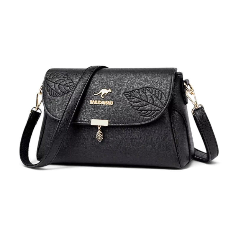Sac bandoulière femme cuir noir motif feuille, vue de trois quarts
