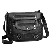 Sac bandoulière femme en cuir noir ornements coeur