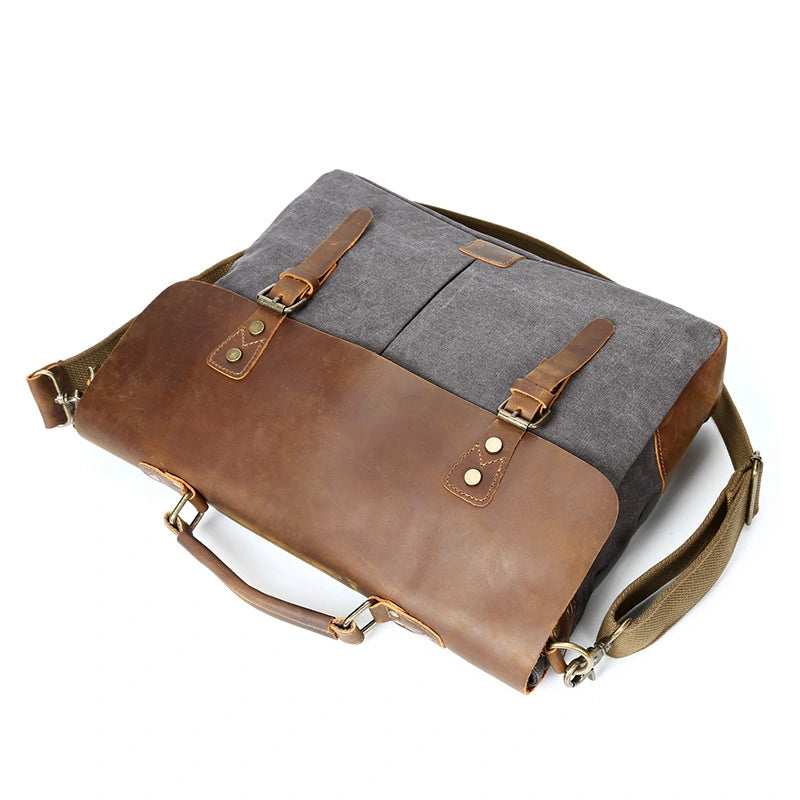 Sac besace homme en toile et cuir, posé à plat